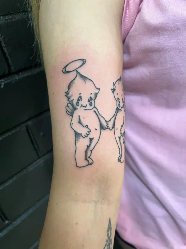 Small fine-line character tattoo on an arm